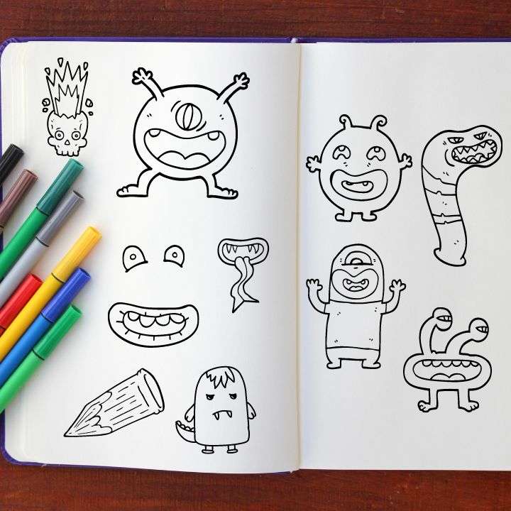 Different drawings of monsters on a sketch pad