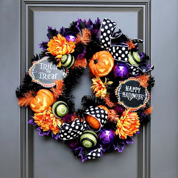 A wreath using artificial pumpkins and gourds for a timeless Halloween look