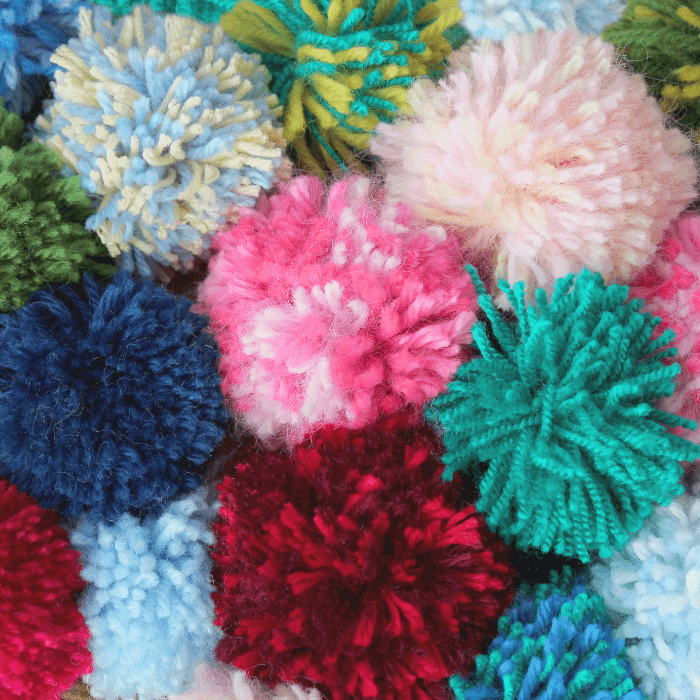 Fluffy colored wool pom-pom from threads for knitting yarn