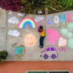 Kid creatively doodling on the pavement. chalk art, easy chalk drawings, things to draw with chalk, easy chalk art, chalk art easy, what to draw with chalk, easy things to draw with chalk, easy beginner chalk art