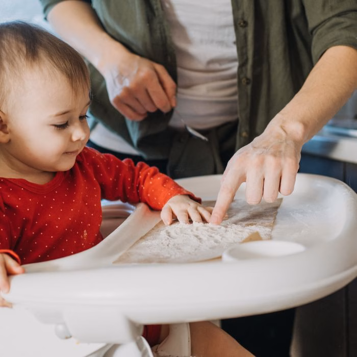 baby playing with flour